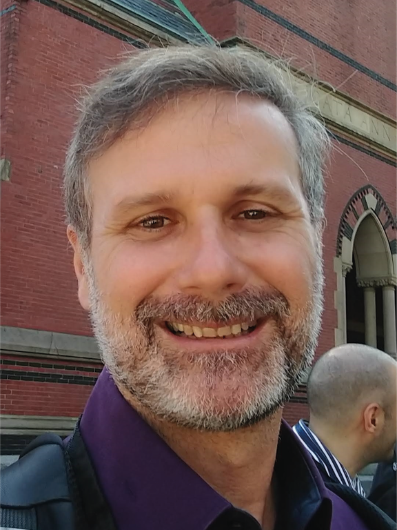 White man, brown hair, using red shirt