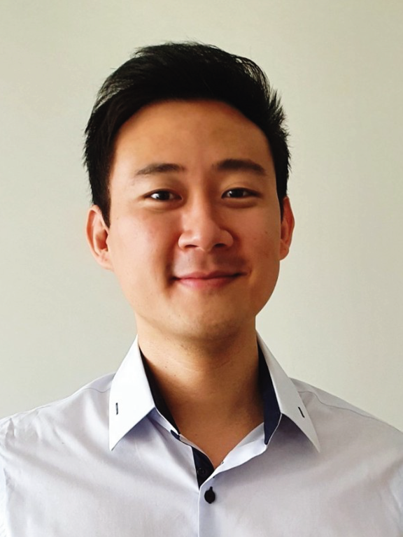 Male, Japanese ancestry, dark and short hair, blue shirt with dark button, bright background