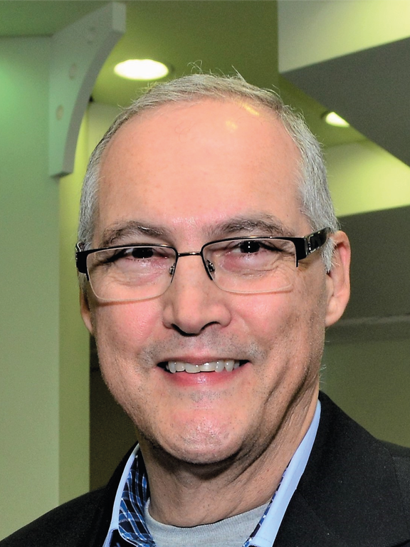 Male, white, middle-age, grey hair, wearing glasses, smiling